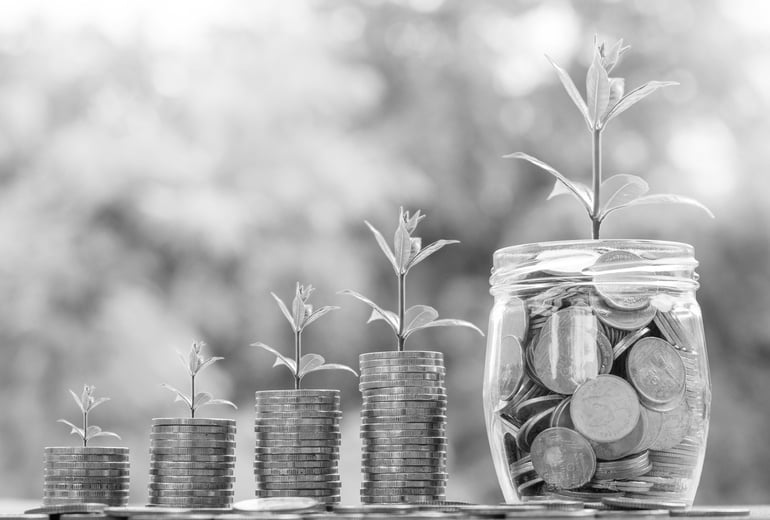 Plants Growing From Piled Coins